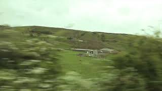 view of green hills from car window with motion blur