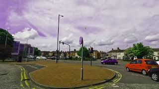 car on a roundabout with purple sky