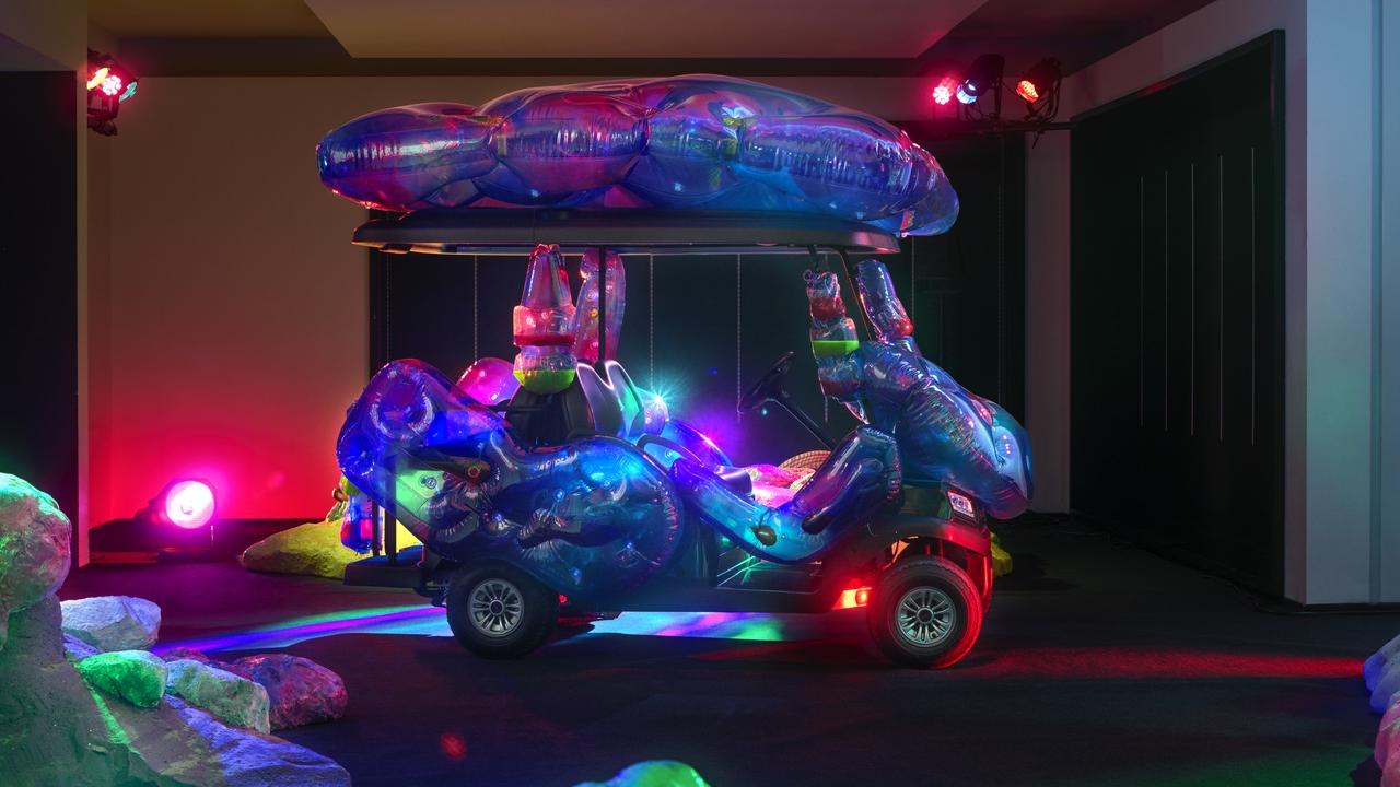 a colourful moon buggy in a dark room
