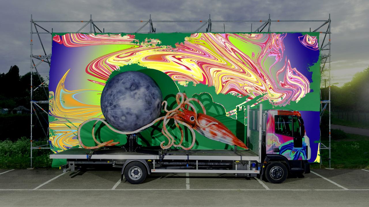 a giant squid and a giant moon on the back of a truck